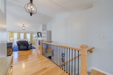 Lightly stained hardwood flooring throughout most 