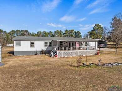 Manufactured / mobile home with a carport, a deck,