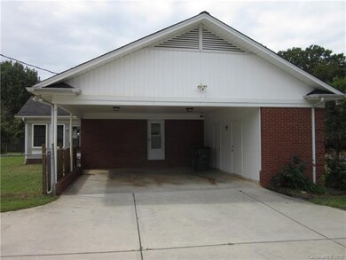 Two car carport also has nice size storage room an