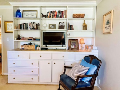 Living area with ornamental molding and baseboards