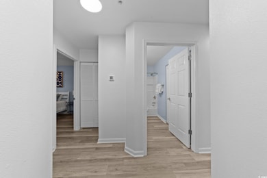 Corridor with light hardwood / wood-style floors