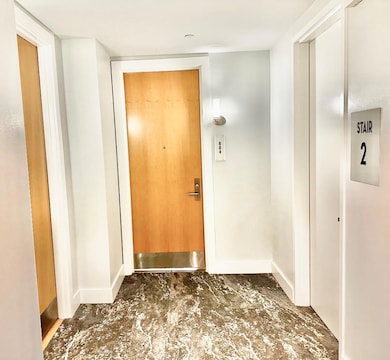 Doorway to outside with baseboards