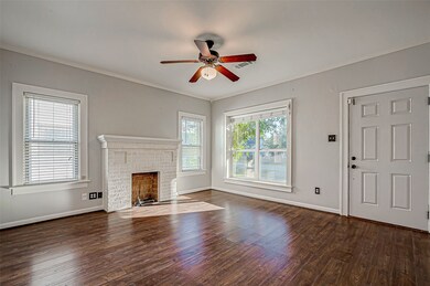 Formal living room with mock fireplace, hardwoods