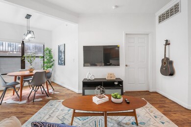 Living room with wood finished floors and crown m
