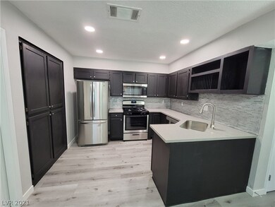 Kitchen with stainless steel appliances, newly rai