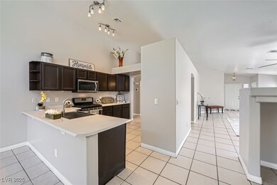 Kitchen with light tile  floors, a breakfast bar c