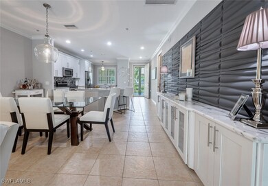Dining room with ornamental molding, light tile pa