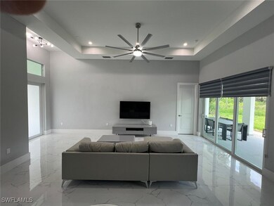 Living room with ceiling fan and a towering ceilin