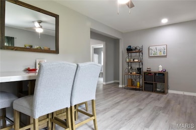 Dining area featuring a ceiling fan and light wood finished floors