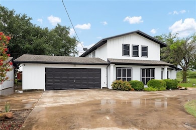 View of front of house with an attached garage and driveway