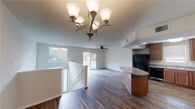 Kitchen with a center island, a sink, dark wood-s