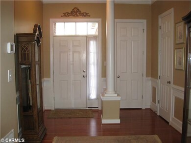Foyer - Wood Floors, Half Bath & Entrance to Laund