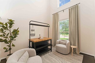 Versatile front room with big windows—use it as a