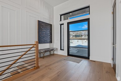 Entrance foyer featuring light wood-style flooring and baseboards