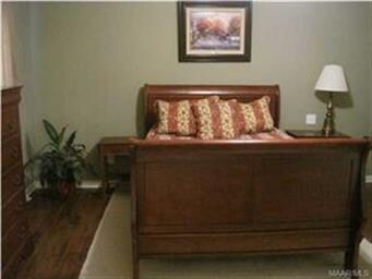 Master bedroom with wood floors.