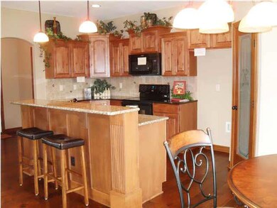 Cabinetry is Knotty Alder in a Bronze Color.