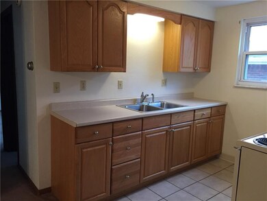 This kitchen has a ceramic floor and an electric s