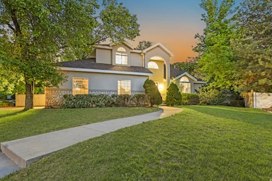 View of front facade featuring stone siding, stucco siding, and a shingled roof