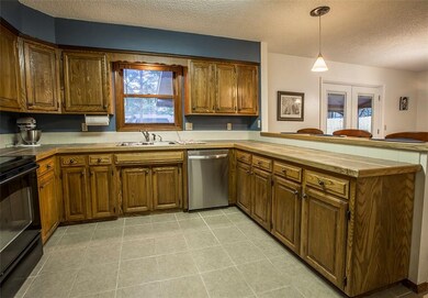 Lots of cabinets in this spacious kitchen window looks ou to the back yard