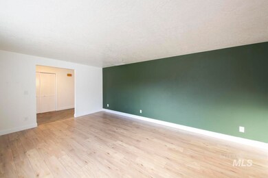 Unfurnished room with a textured ceiling and light wood-style flooring