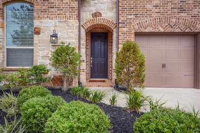 Exterior upgrades with brick, stone elevation and beautiful front door.