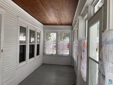 Unfurnished sunroom with wooden ceiling