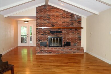 Interior, entryway, living room, wood burning fireplace that vents throughout, hardwoods