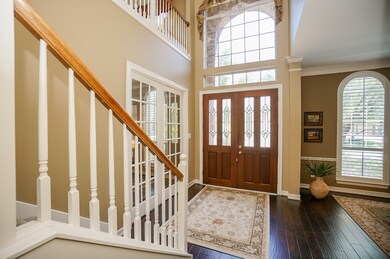 Your elegant entry/foyer boasts a vaulted ceiling and magnificent arched windows above the doors; rich wood floors, earth tones on the walls with double classic crown molding, and space, galore! And, that's only the beginning!