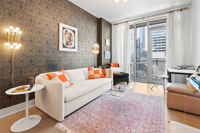 Living area with baseboards, wallpapered walls, a
