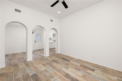 Unfurnished room with ceiling fan and light hardwood / wood-style floors