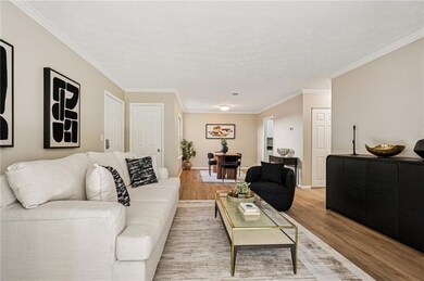 Living room featuring ornamental molding and wood finished floors