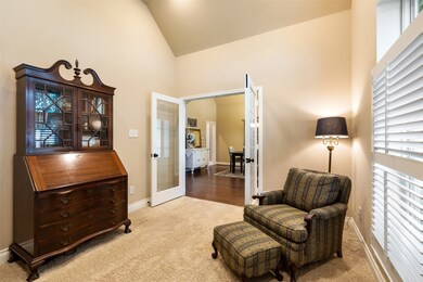 French doors near the foyer open to an executive study/library with clean carpet, plus high slanted ceilings with upgraded recessed lighting.