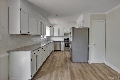 Kitchen with granite countertops, tile backsplash