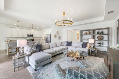 Living room with a notable chandelier and a tray c