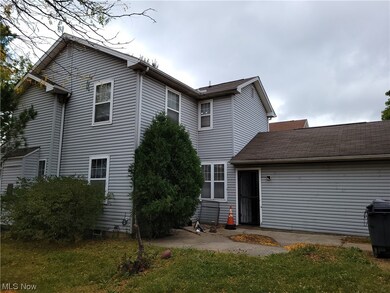 Rear view of house featuring a yard