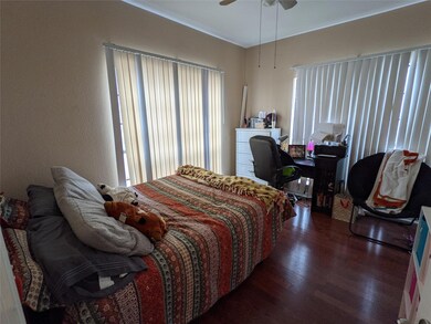 Bedroom featuring wood finished floors, a ceiling