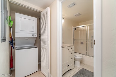 Washroom with light tile patterned flooring and st