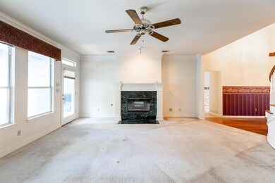 Unfurnished living room with ceiling fan, crown mo
