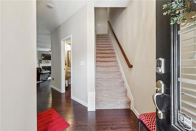 Foyer featuring wood finished floors, stairway, baseboards, and a ceiling fan