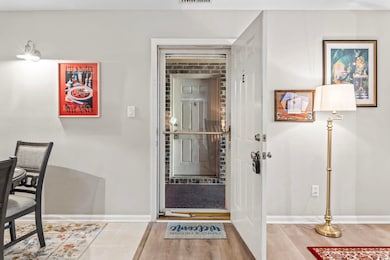 Entryway with visible vents, baseboards, and wood 