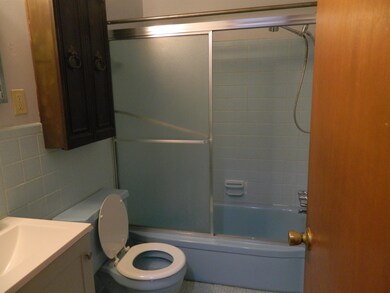 Full bathroom with tile walls, enclosed tub / show