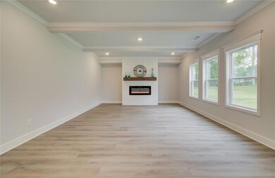 Unfurnished living room with crown molding, recessed lighting, light wood-type flooring, baseboards, and a fireplace