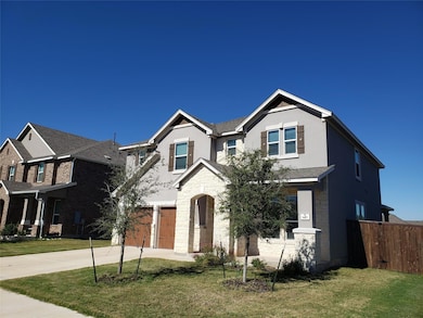View of front of property with driveway, an attached garage, stucco siding, and stone siding