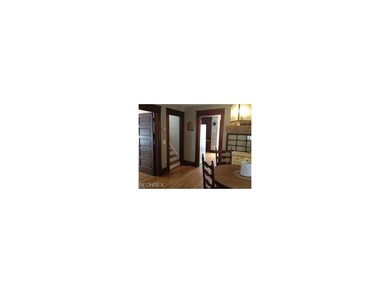 Dining room looking into kitchen and stairs to sec
