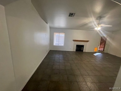 Unfurnished living room with a tiled fireplace and