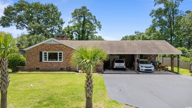 Ranch-style home with crawl space, brick siding, driveway, a chimney, and an attached carport