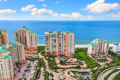 Aerial view of apartment complex and expansive coastline