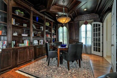 The 17' x 14' Library features hardwood floors, built-in bookcases and recessed lighting.  The French doors lead into the entry foyer.