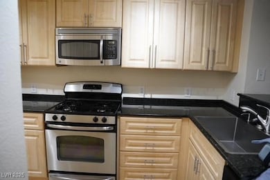 Kitchen with stainless steel appliances, a sink, a