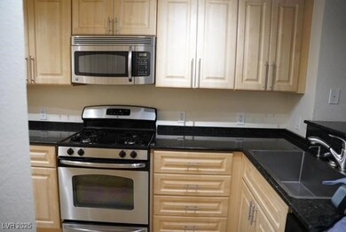 Kitchen with stainless steel appliances, a sink, a